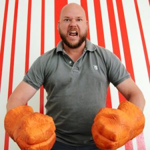 An image of a person wearing orange Hulk hands