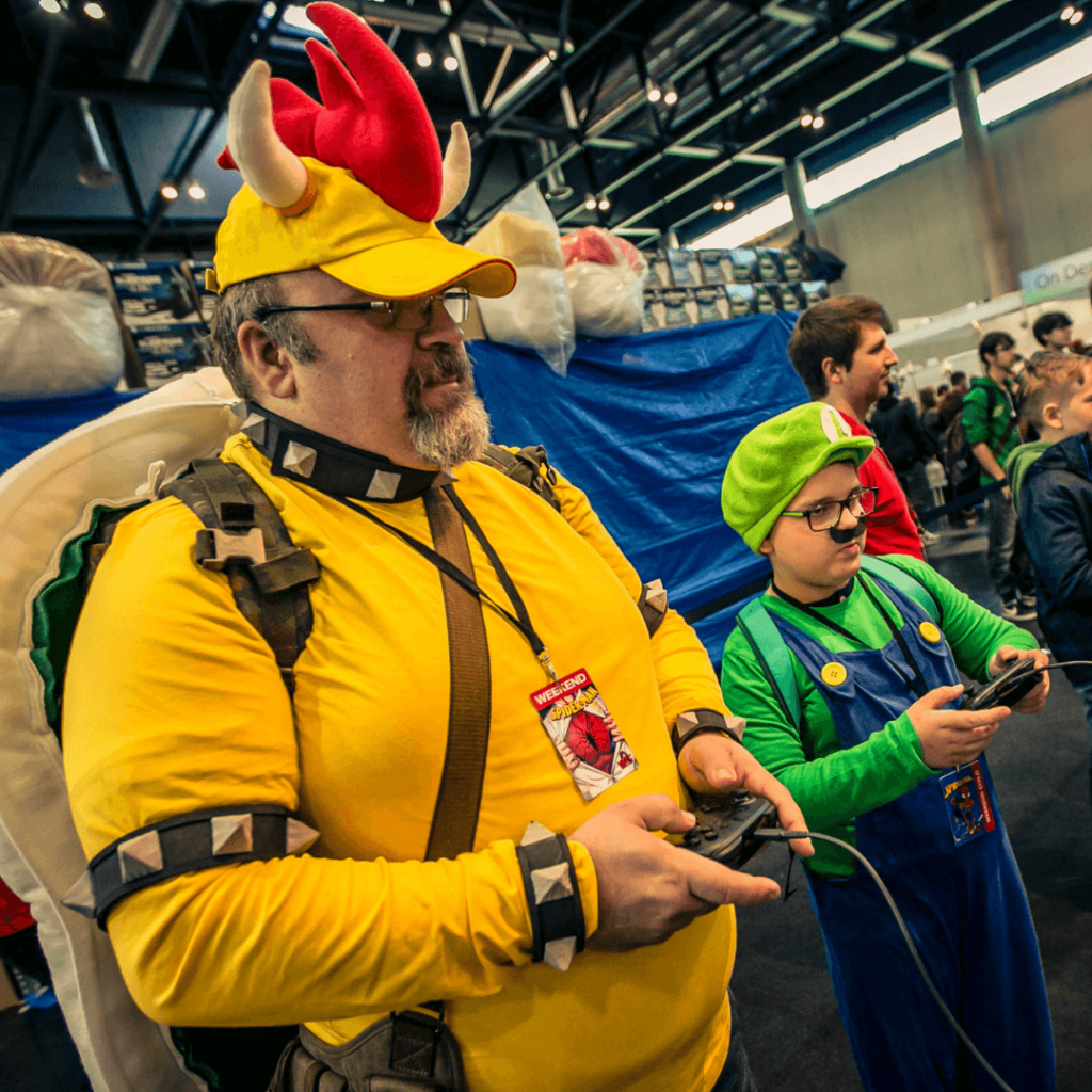 Father and son, playing video games, Bowser and Luigi cosplay